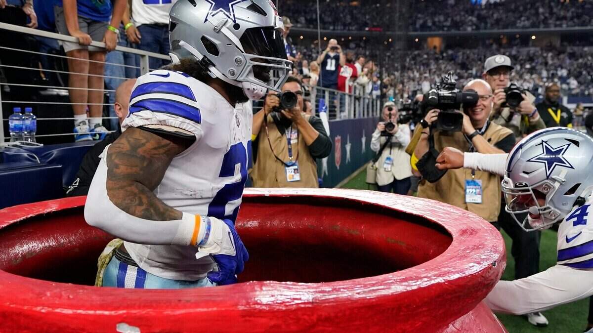 Dallas Cowboys’ Ezekiel Elliott (21) celebrates a touchdown run during the second half of an NFL football game against the Indianapolis Colts, Sunday, Dec. 4, 2022, in Arlington, Texas..