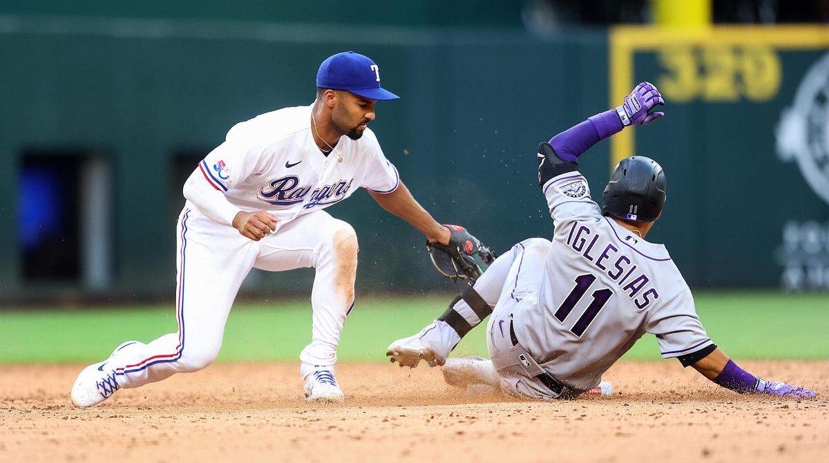 Texas Rangers second baseman Marcus Semien tags out Colorado Rockies shortstop José Iglesias on Monday, April 11, 2022, at Globe Life Field.