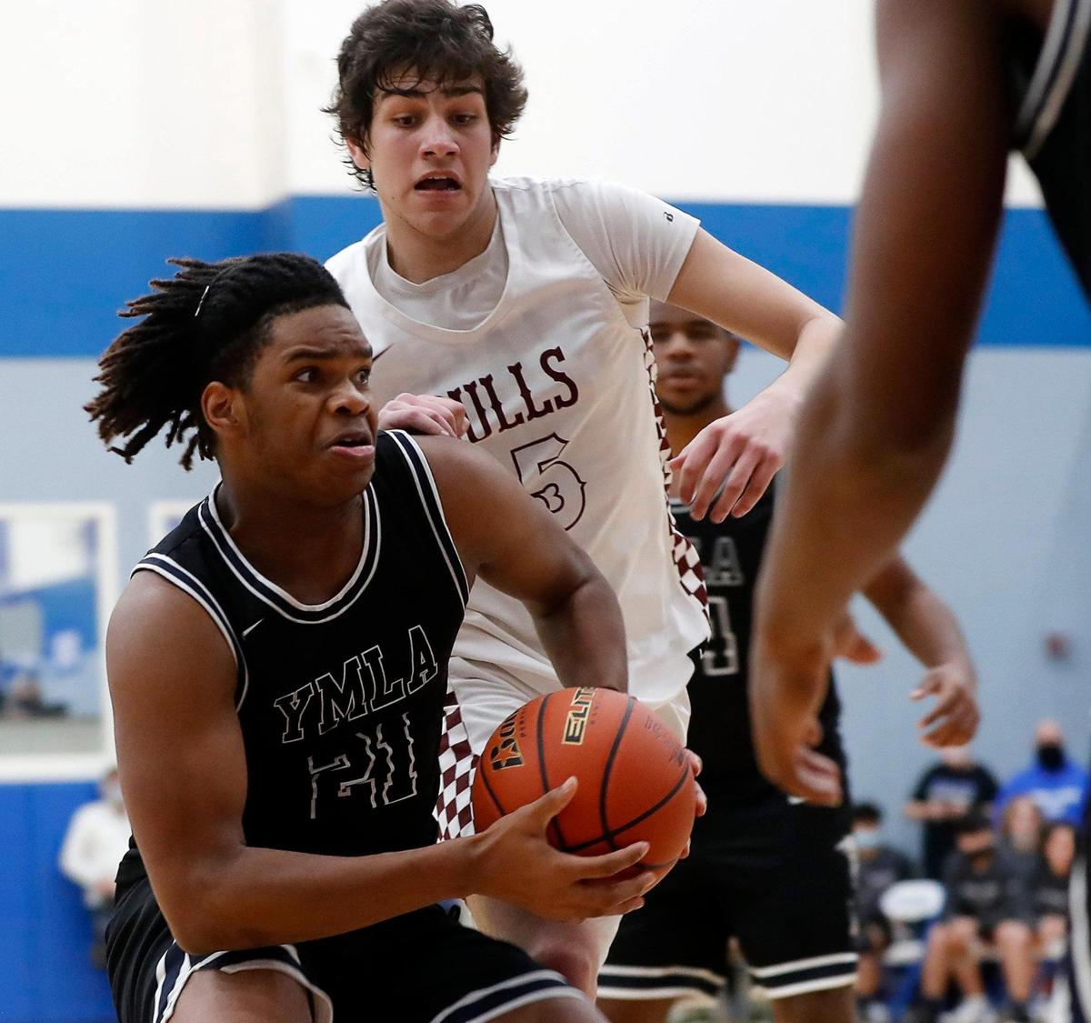 YMLA’s Jordan McClendon (21) drives to the key for two during a 4A Region 1 bi-district basketball game at Brewer High School in Fort Worth, Texas, Monday, Feb. 22, 2021. YMLA defeated Bridgeport 67-60 in overtime. (Special to the Star-Telegram Bob Booth)