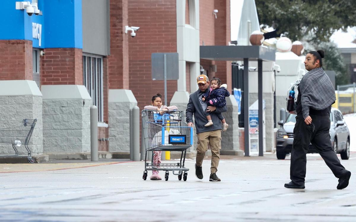 Shopper come and go from a Walmart in Arlington on Friday, Jan. 10, 2025, in Arlington. The winter storm warning in effect for North Texas has been downgraded to a winter weather advisory, according to the National Weather Service Fort Worth.