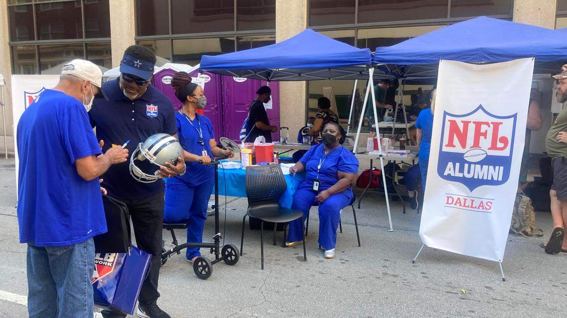 Former Dallas Cowboys safety George Teague joined other retired NFL players on Saturday in downtown Fort Worth to promote an effort to offer free COVID vaccines.