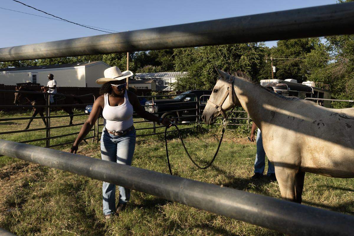 Circle L5 riding member Koleen Busby helps her daughter Madlyn Walter, 10, train her young horse Bam Bam at Papa Doddie Arena in east Fort Worth.