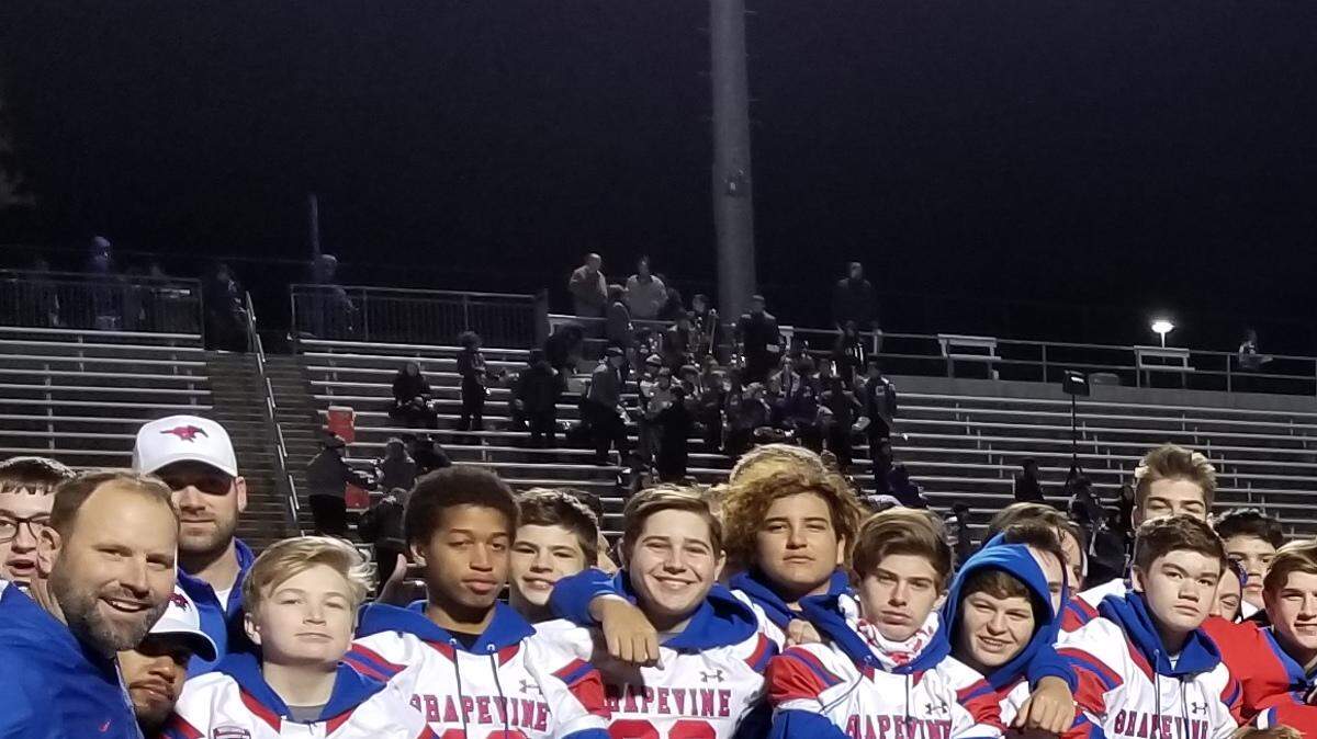 Grapevine celebrates with its bi-district trophy after defeating Crowley 34-14 in the Class 5A Division I playoffs.