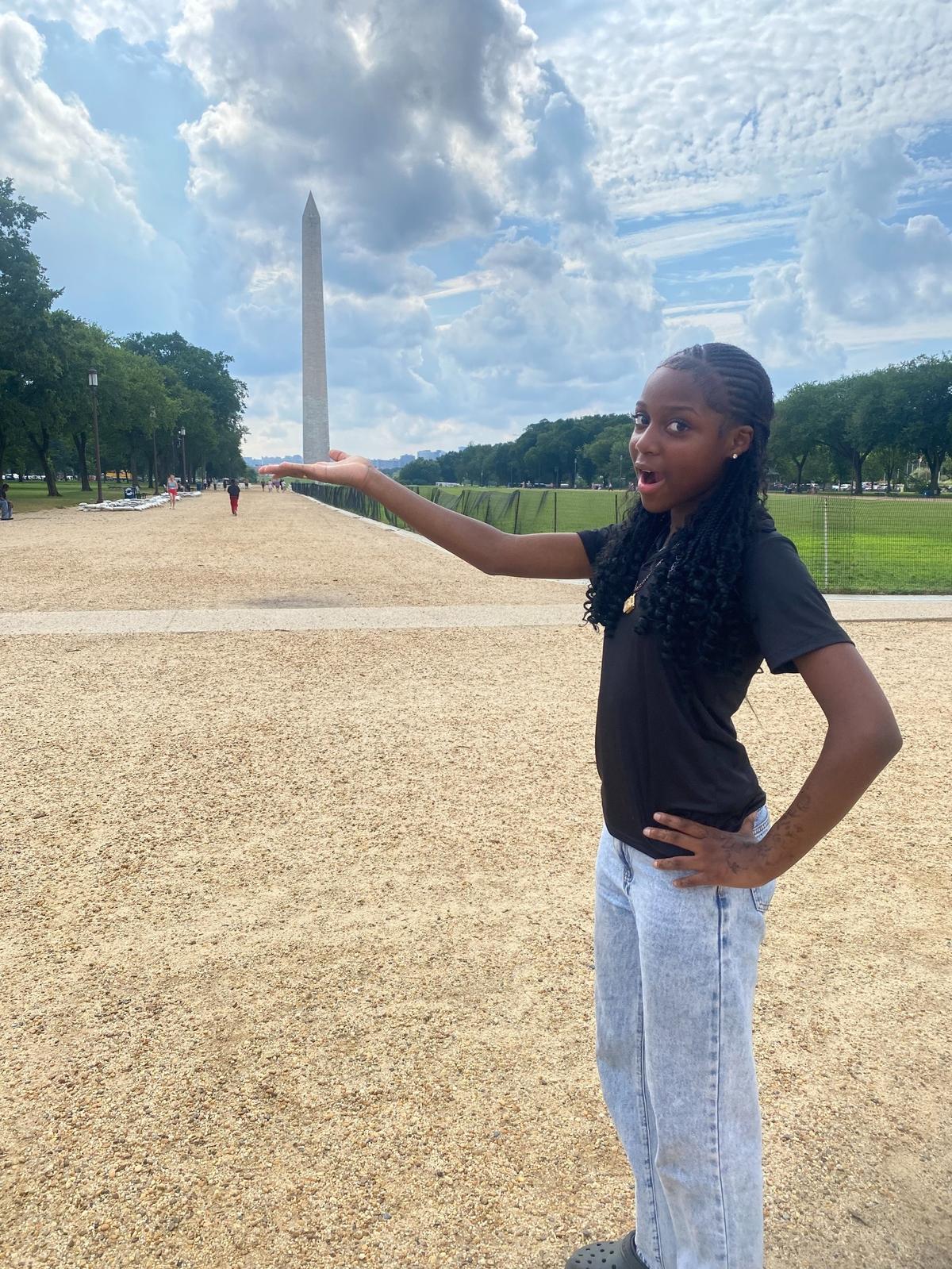Masoka Peter pretends to hold up the Washington Monument in what was her her first trip to Washington, D.C., during the National PAL 2025 Leadership and Mentor Youth Summit.