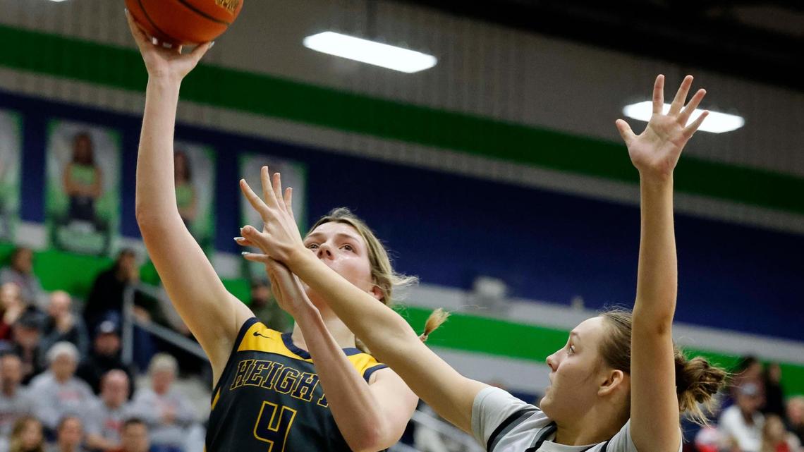 Arlington Heights forward Caroline Ramsey (4) puts in a right hand layup over the defense of Argyle guard Brooke Maupin (0) during the first period of a UIL Conference 5A Region 1 Area Round Championship basketball game at Haslet Eaton High School in Fort Worth, Texas, Friday, Feb. 16, 2024.