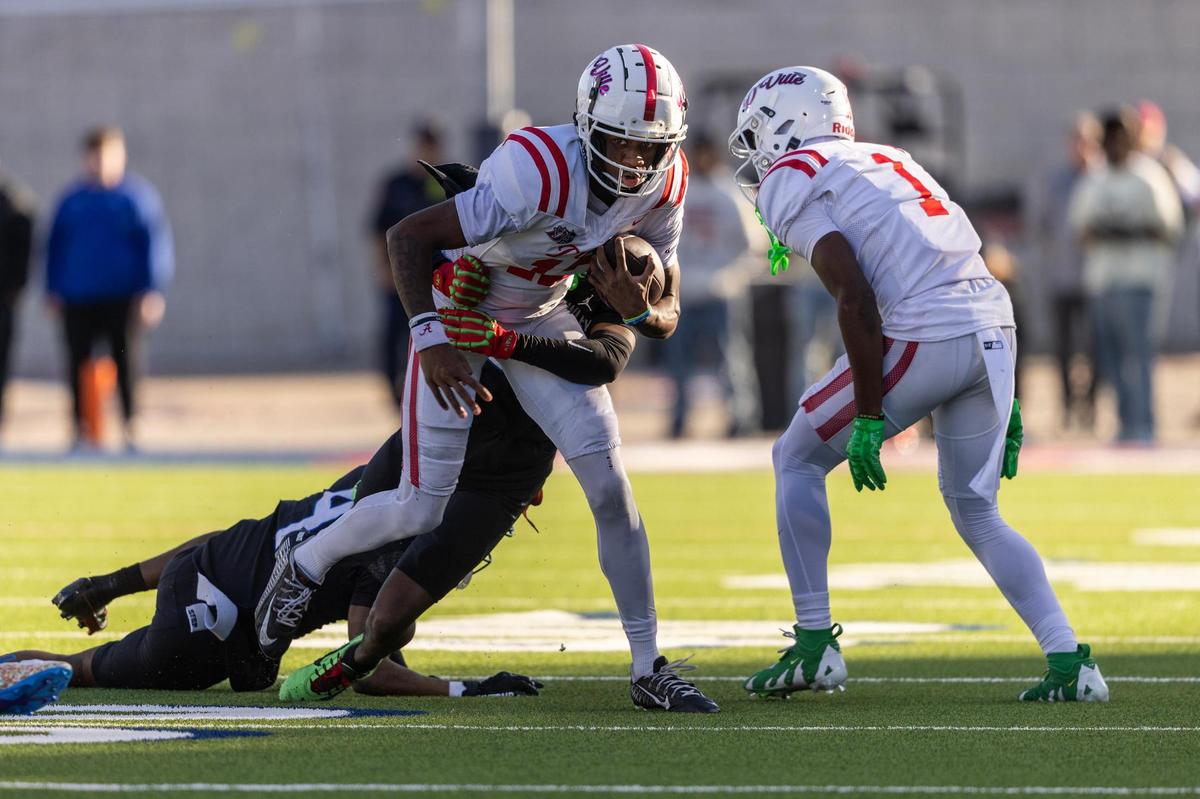 Duncanville quarterback Keelon Russell (12) is tackled in the back field during the first half of the Class 6A Division I state semifinal game at Eagle Stadium in Allen on Saturday, Dec. 14, 2024.