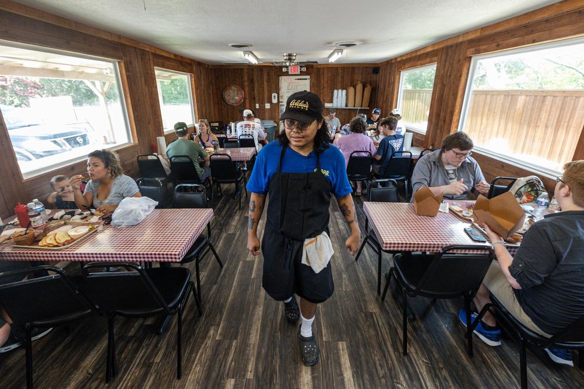 Nupohn Inthanousay, a co-owner of Goldee’s Barbecue, checks in on the customers dining at Goldee’s in Fort Worth on Friday, June 28, 2024.