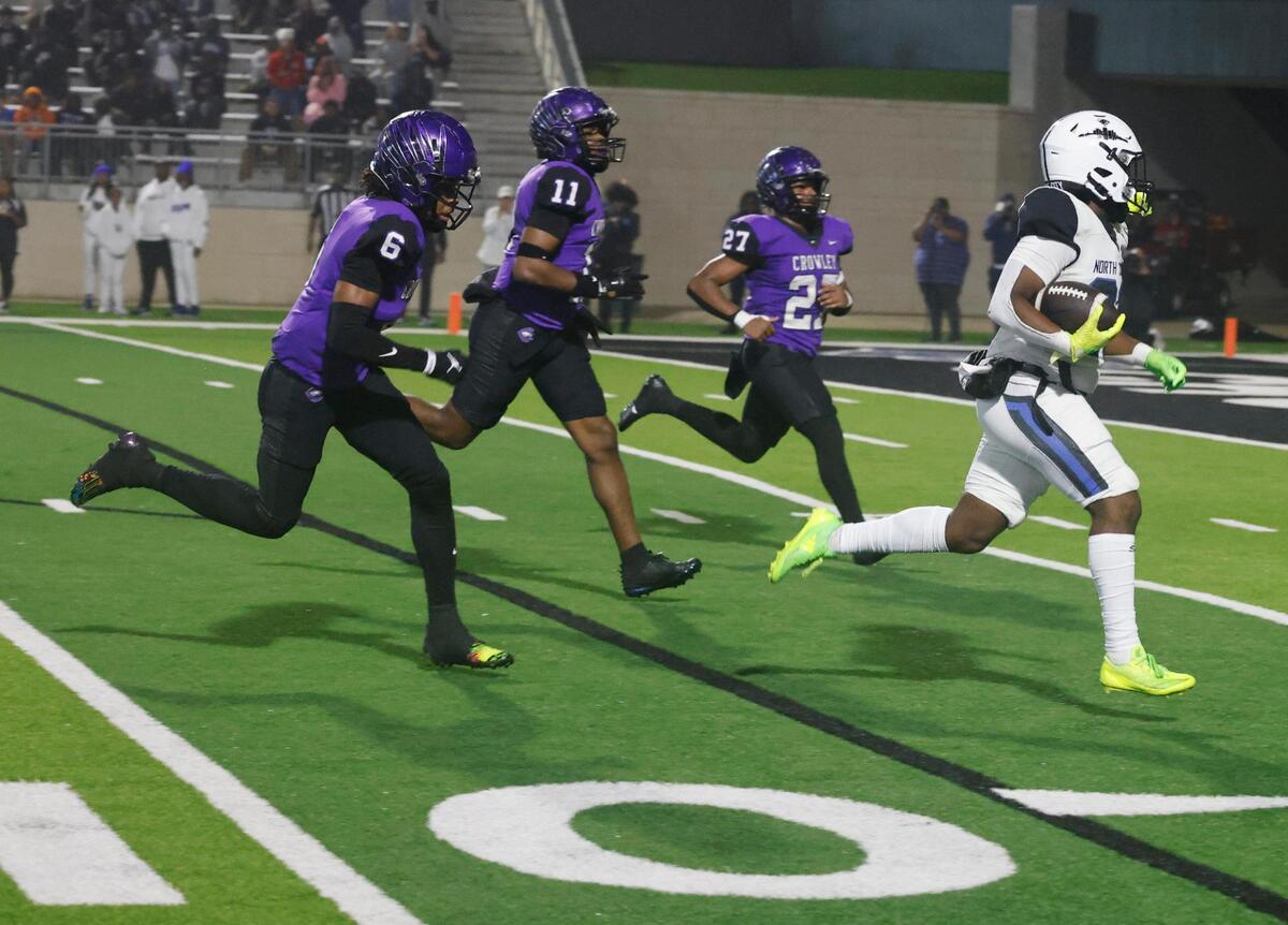 North Crowley running back Kiante Ingram (23) leads the Crowley defense of corner back Brandon Ford (6), linebacker Kameron Walker (11) and free safety Jonathan Blake (27) to the end zone during a UIL District 3-6A football game at Crowley ISD Multi-Purpose Stadium in Fort Worth, Texas, Thursday, Nov. 07, 2024.