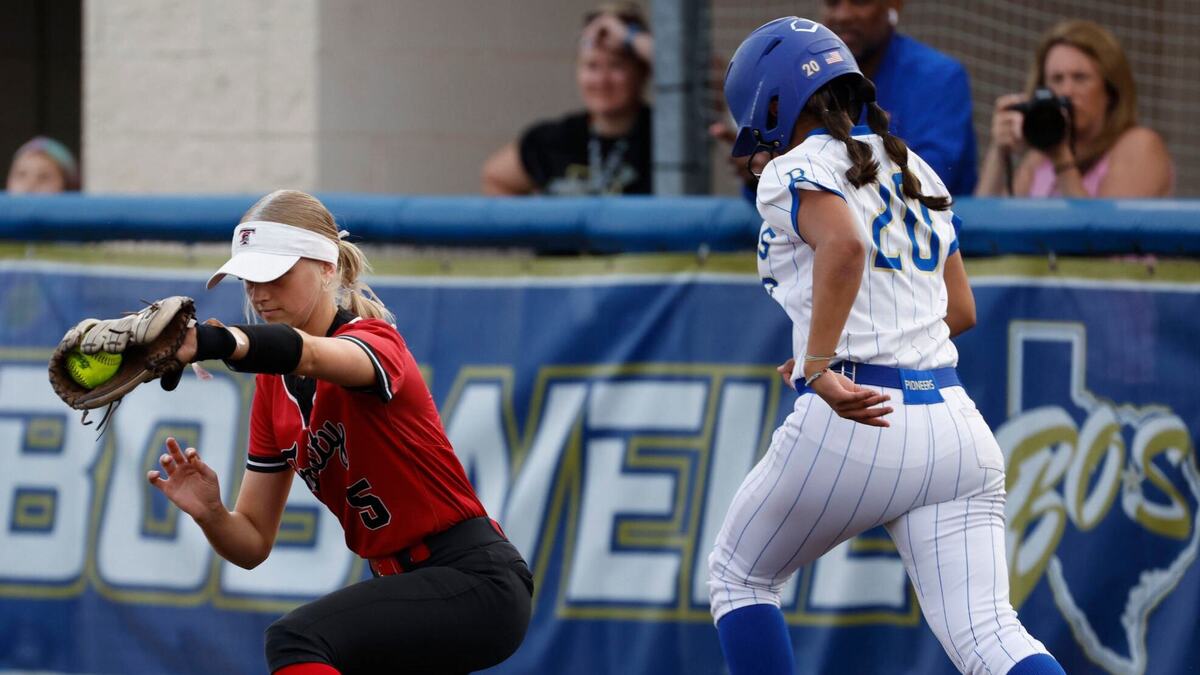 Trinity first baseman Taci Mitchell (5) gets Boswell third baseman Ashlynn Cerda (20)during a high school softball game at Boswell High School in Saginaw, Texas, April 16, 2024. Boswell defeated Trinity 6-0 which left the two teams tied for first place. (Special to the Star-Telegram/Bob Booth)