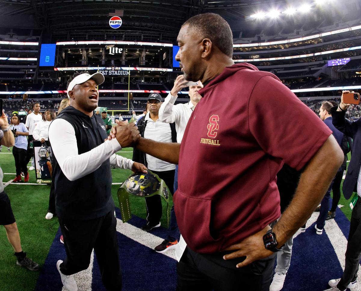 DeSoto head coach Claude Mathis and Summer Creek head coach Kenny Harrison shake hands after the UIL Conference 6A Division 2 state championship football game at AT&T Stadium in Arlington, Texas, Saturday, Dec. 16, 2023.