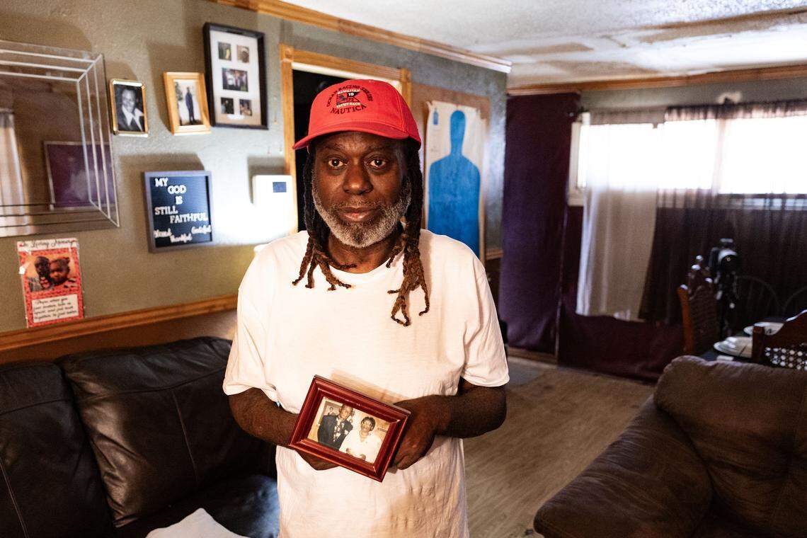 Scotti Choice gets tears in his eyes while being photographed holding a photo of his mother, Gloria Choice, in his house in Fort Worth on Nov. 8, 2025. Choice’s mother was found beaten to death in a vacant apartment in 2005 and her killer has not been found. “I just can’t give up hope that they’ll be able to find out what happened,” Choice said.