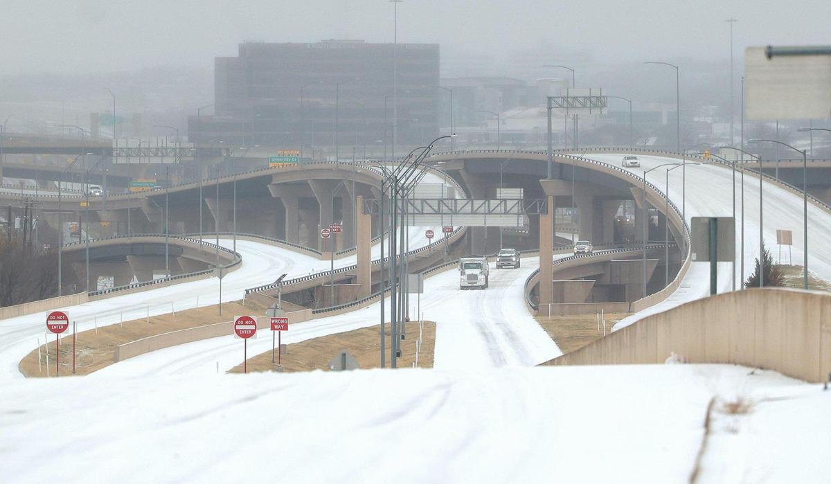 Vehicles slowly drive on Interstate 30 near downtown Fort Worth on Tuesday, January 31, 2022. Winter storm and ice storm warnings are extended through 6 a.m. Thursday and freezing rain is expected most of Tuesday and Wednesday, officials said.