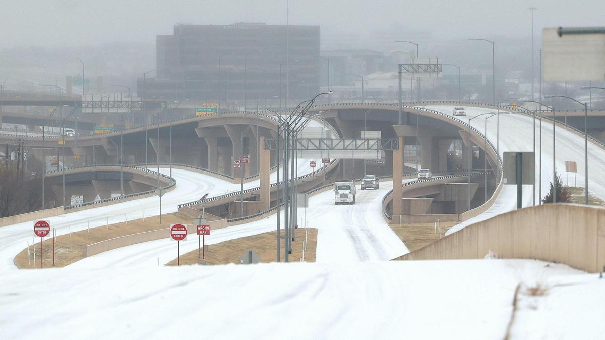 Vehicles slowly drive on Interstate 30 near downtown Fort Worth on Tuesday, January 31, 2022. An ice storm warning is in effect until 9 a.m. Thursday and freezing rain is expected most of Wednesday, officials said.