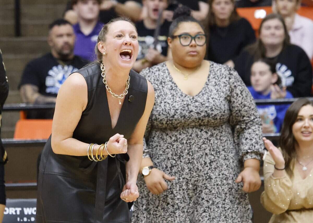 Eagle Mountain head coach Catherine Foerster urges on her team after a point during the second set of a UIL Conference 4A D2 State Semifinal volleyball playoff game between Eagle Mountain and Spring Hill at Wilkerson-Greines Activity Center in Fort Worth, Texas, Saturday, Nov. 15, 2025.