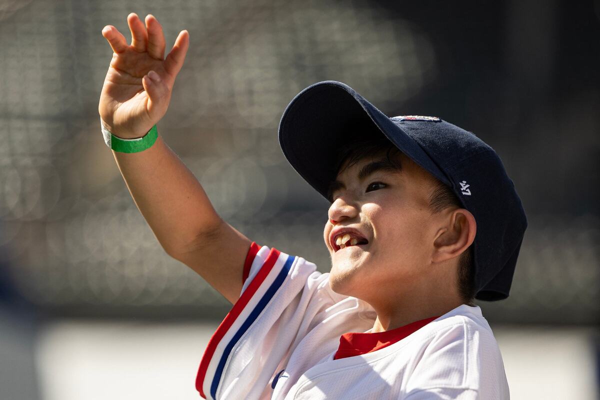 Evan Hinojosa, 10, waves to his family in the stands after getting on base during a game in the Play Ball Field for the first day of the 2024 MLB All-Star Village at Choctaw Stadium in Arlington on Saturday, July 13, 2024.