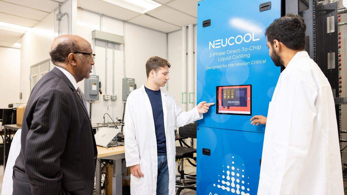 Dereje Agonafer, left, inspects a cooling distribution unit at UT Arlington with PhD students Braxton Smith, center, and Sai Abhideep Pundla on July 29, 2025. Agonafer’s research team ranks among the nation’s leaders in finding more efficient ways to cool AI computing chips.