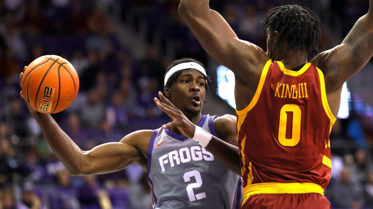 TCU forward Emanuel Miller (2) looks to pass around Iowa State forward Tre King (0) during the first half of an NCAA college basketball game, Saturday, Jan. 7, 2023, in Fort Worth, Texas. (AP Photo/Ron Jenkins)