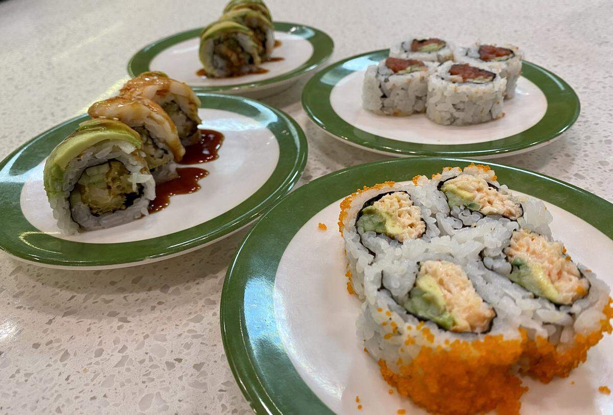 A “red” California roll, spicy tuna roll, “Caterpillar” roll and “Tiger” roll at Akarii Revolving Sushi.