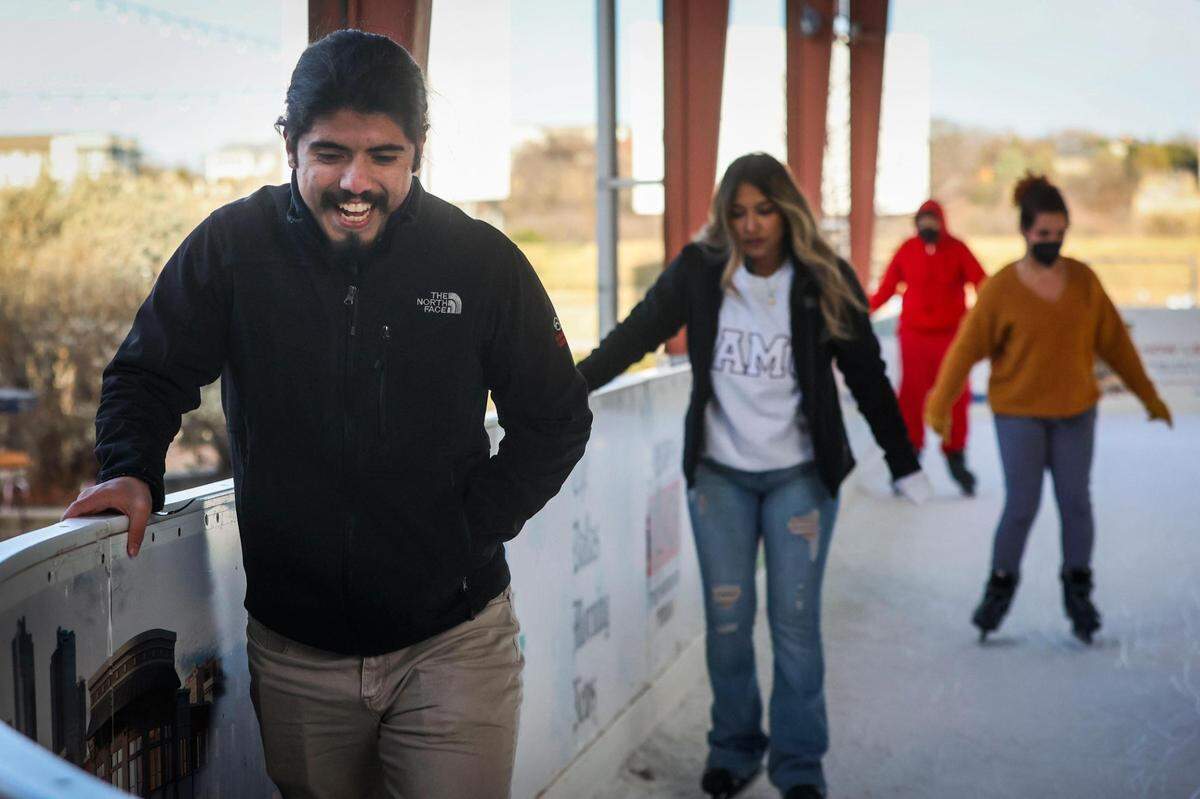 Sergio Alonzo followed by Selena Cruz skate amid a COVID surge Thursday, Jan. 6, 2022, at Panther Island Ice in Fort Worth.