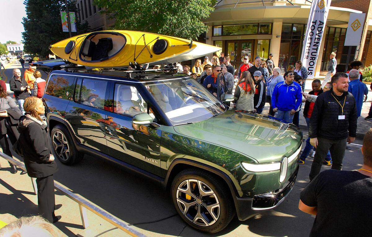 Large crowds turned out to look at Rivian Automotive’s R1S prototype during a public rollout of the company’s new vehicles in Normal, Illinois, Sunday, Oct. 13,2019. The company is manufacturing a pickup and the sports utility vehicle as the world’s first electric “adventure vehicles” in Normal. (David Proeber/The Pantagraph via AP)