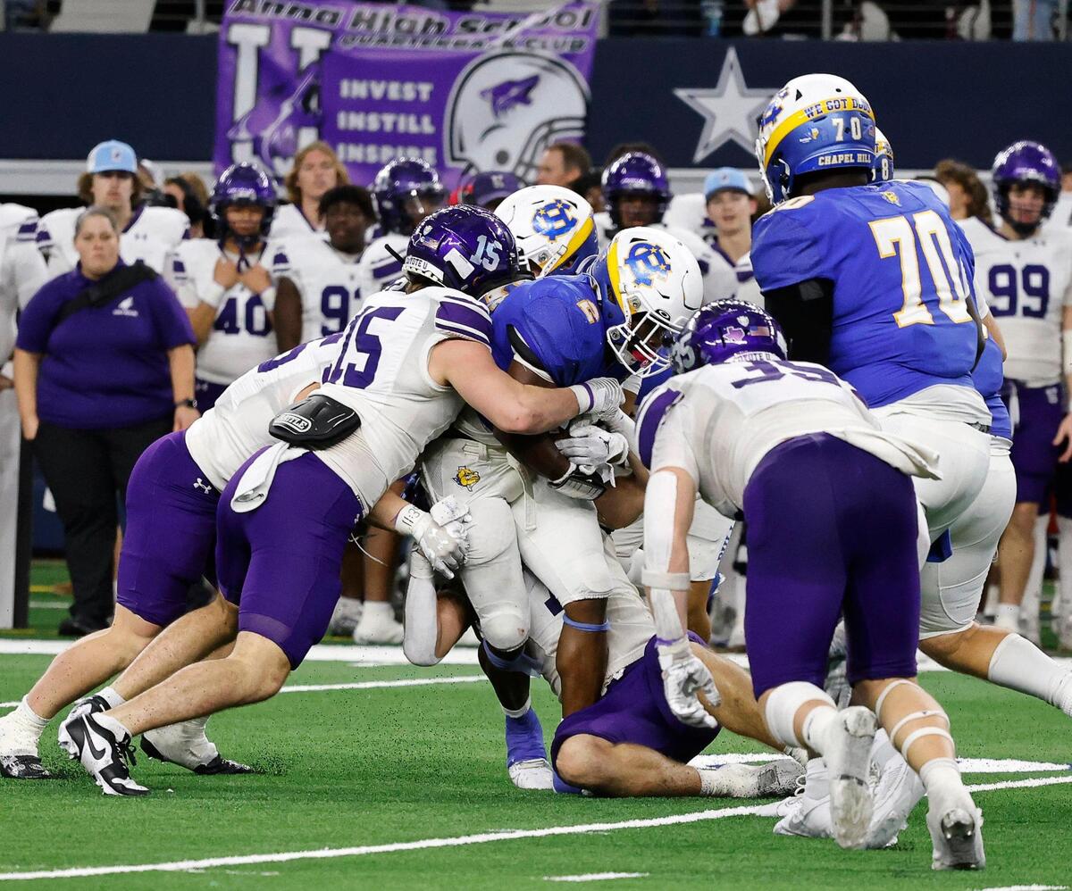 Chapel Hill running back Ja’borian Cook is smothered by the Anna defense during the UIL Conference 4A Division 1 state championship football game at AT&T Stadium in Arlington, Texas, Thursday, Dec. 14, 2023.