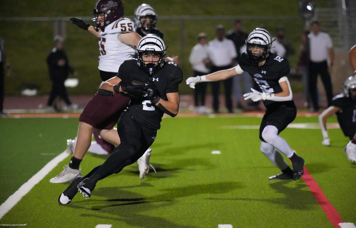 Grandview’s Kason Sanders (2) looks for room to run after one of his two interceptions on the night against Whitesboro on Thursday, November 14, 2024 at Mustang-Panther Stadium in Grapevine, Texas. Grandview defeated Whitesboro 54-17.