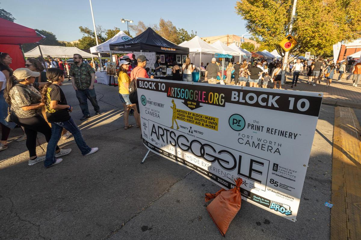 Event attendees take a look around the hundreds of vendors selling their art during the Arts Goggle event on Magnolia Avenue in Fort Worth on Saturday, Oct. 19, 2024.