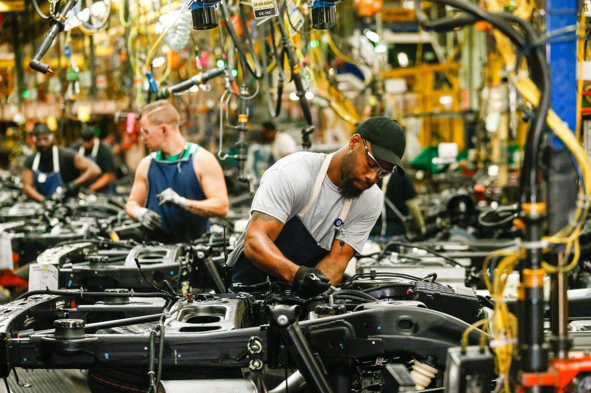 General Motors employees work on the assembly line at GM’s Arlington Assembly in 2019.