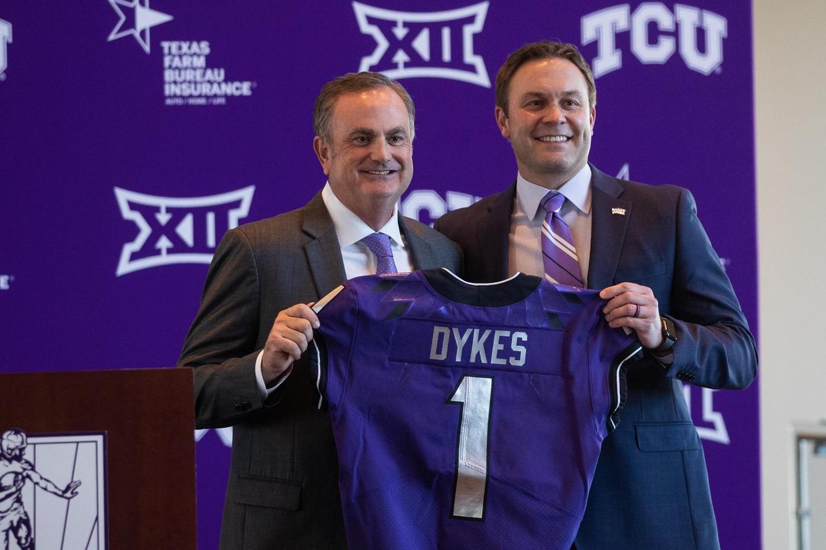 The new TCU football head coach Sonny Dykes and Athletics Director Jeremiah Donati hold up a jersey at a press conference Tuesday, Nov. 30, 2021, at Amon G. Carter Stadium.