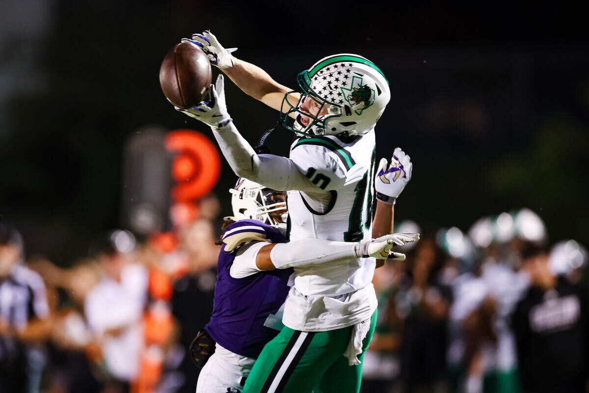 Southlake Carroll wide receiver Brady Knowles attempts to make a catch over a Timber Creek defender in a district matchup between Southlake Carroll and Timber Creek at Keller ISD Stadium on Thursday Sept. 25, 2025.