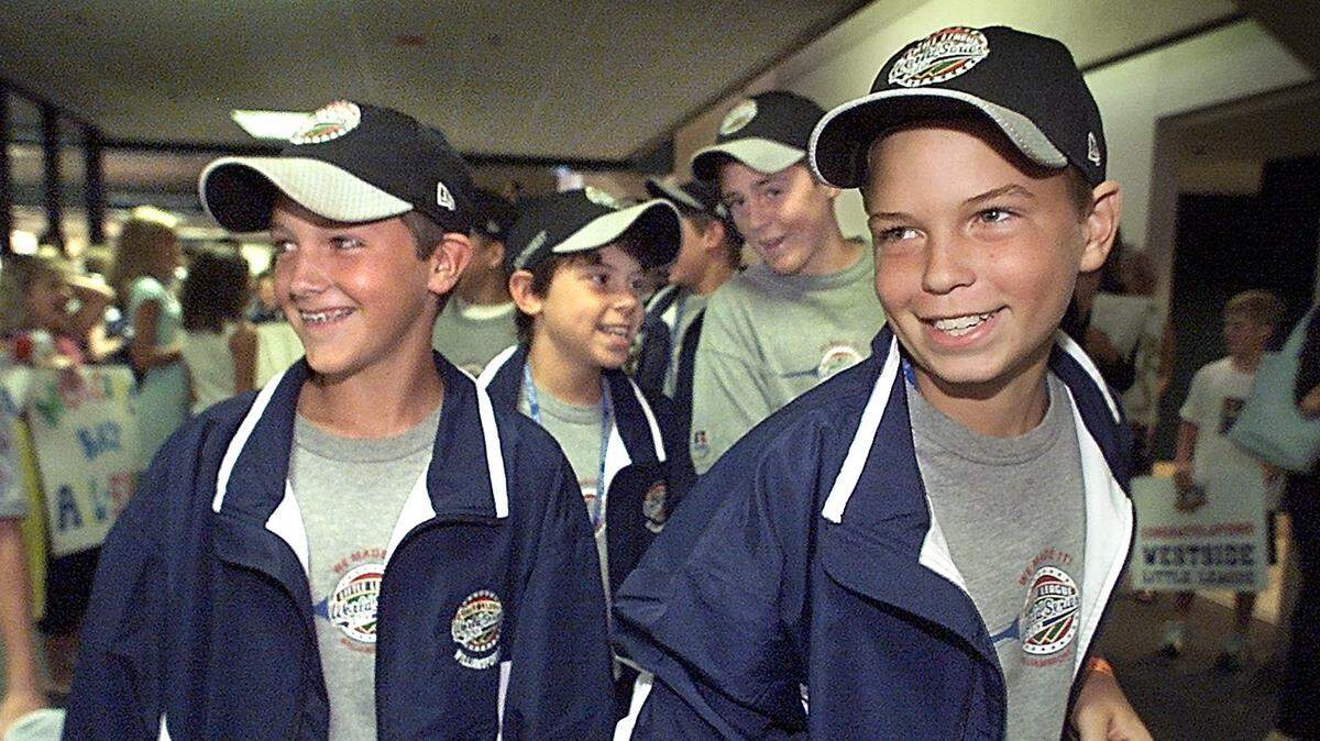 In August 2002, members of the Westside All-Stars Patton Eagle, 12, left, Robbby Lebus, 11, Jack Huckabay, 12, and Mark Grace, 12, returned to DFW after playing in the Little League World Series.