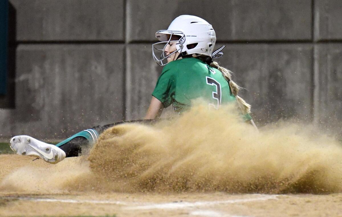 Southlake Carroll’s Morgan Cashon slides into home plate safe to cut theTimber Creek lead 6-2 in the fifth inning of Tuesday’s, April 19, 2022 district 4-6A softball game at Timber Creek High School in Fort Worth, Texas. Timber Creek won 6-3. Special/Bob Haynes