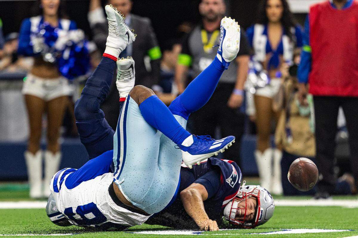Patriots quarterback Mac Jones (10) is sacked by Cowboys defensive lineman Dante Fowler (56) leading to a fumble recovery for a touchdown in the first half on Sunday, Oct. 1, 2023.