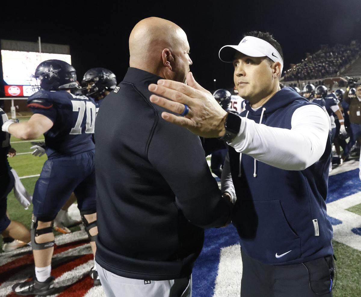 Aledo head coach Robby Jones (left) congratulates Frisco Lone Star head coach Jeff Rayburn after Lone Star won a Class 5A Division I state semifinal Friday at Newsom Stadium in Mansfield.