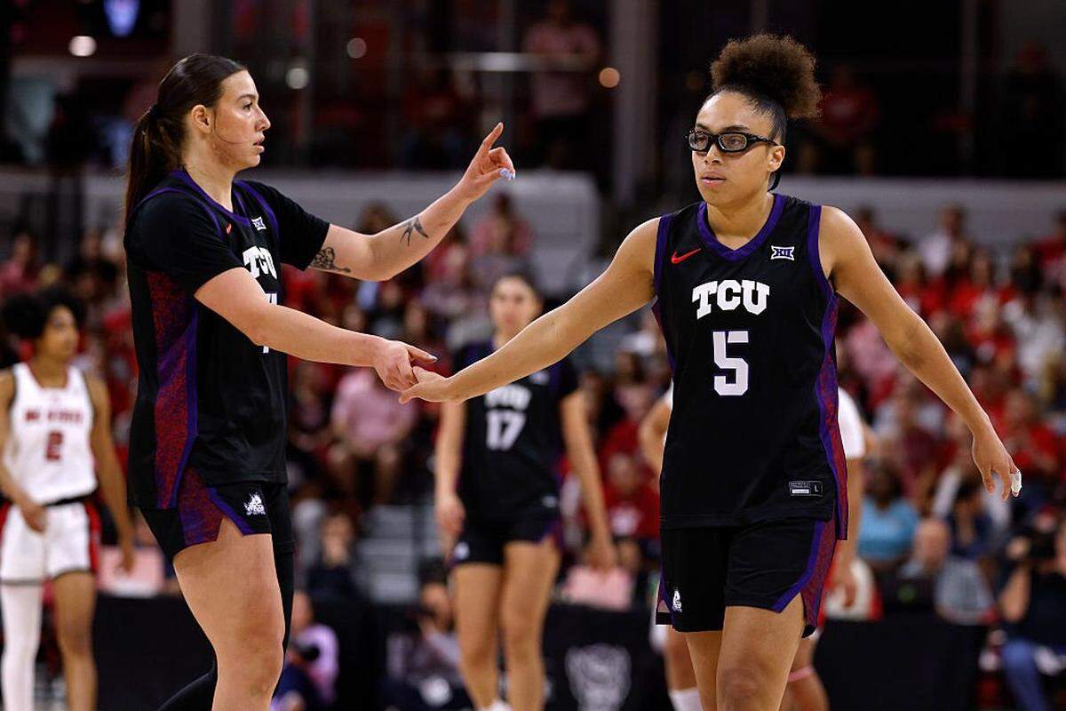 RALEIGH, NORTH CAROLINA - NOVEMBER 16: Olivia Miles #5 high-fives Marta Suarez #7 of the TCU Horned Frogs in the first half against the NC State Wolfpack at Reynolds Coliseum on November 16, 2025 in Raleigh, North Carolina. (Photo by Lance King/Getty Images)