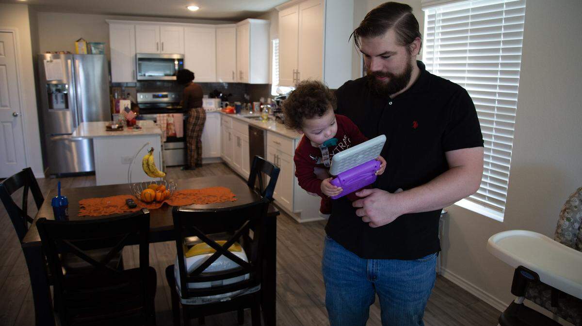 Max Best, holding son Avery, and his wife Jada are celebrating their first Thanksgiving in their new house, thanks to help from nonprofit Operation Homefront.
