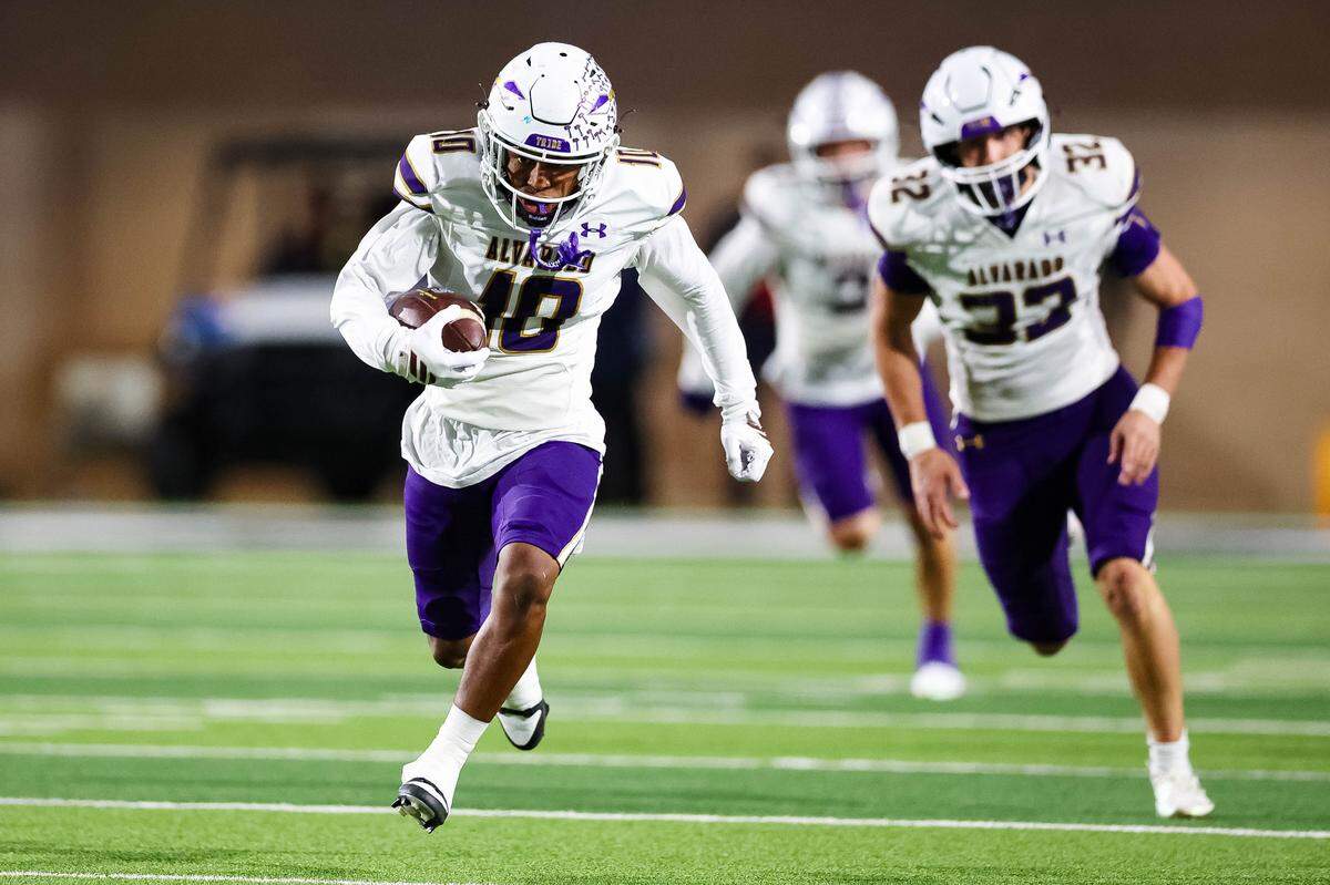 Alvarado defensive back Devin Johnson runs with the football after making an interception in a Class 4A Division I area playoff game against Sulphur Springs on Friday, Nov. 21, 2025, at Children’s Health Stadium in Prosper, Texas.