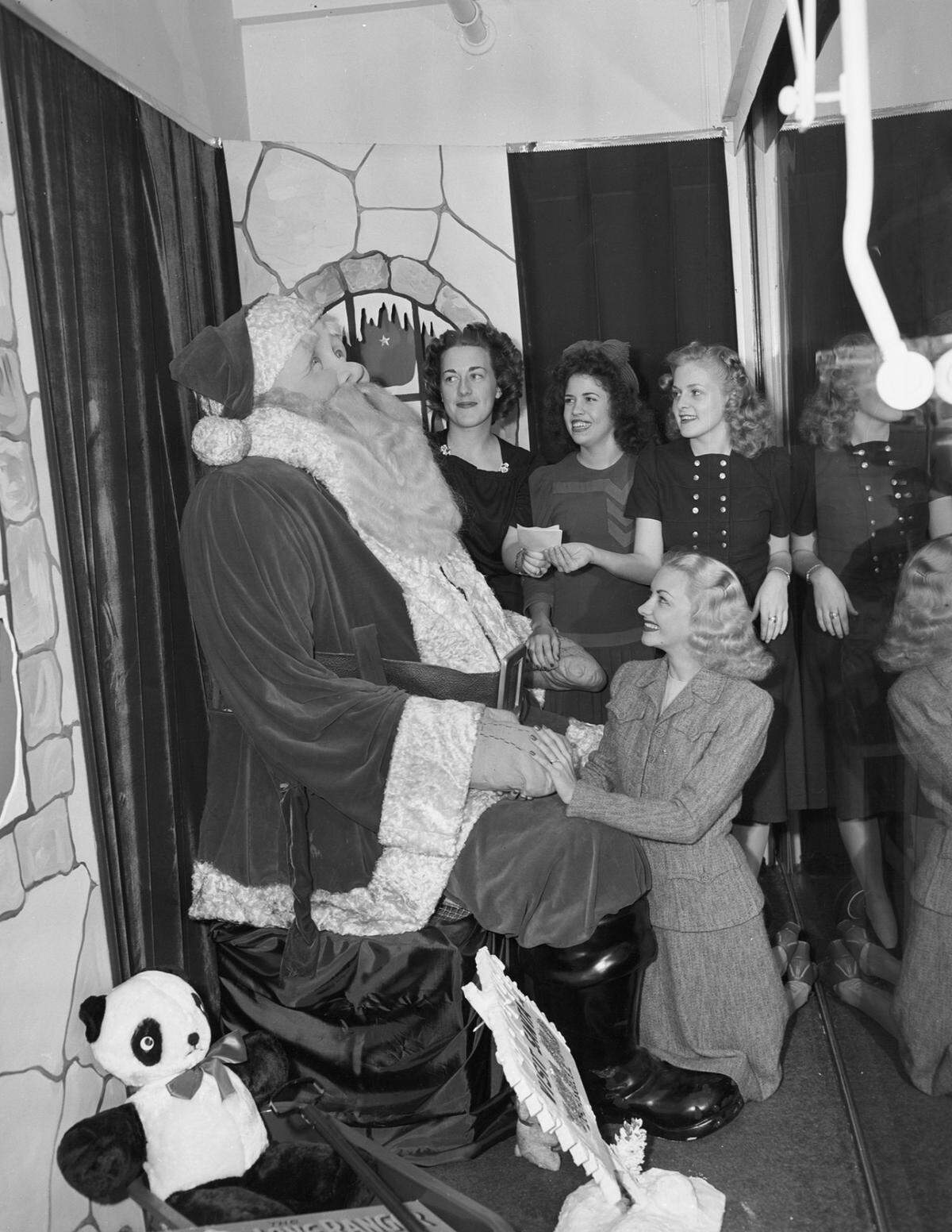 Dec. 4, 1941: These USO workers extended an invitation to the Leonard Brothers Department Store’s Santa Claus statue to attend the Dec. 13 dance in the ballroom of Hotel Texas for soldiers in nearby camps. Miss Virginia Farrell is kneeling in front of Santa Claus. The others, left to right, are Martha Sharp, Marcia Mills and Adelle Whitfill.