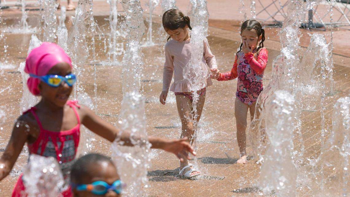 Children splash in the fountains at Sundance Square in downtown Fort Worth, Texas, on July 2, 2022.