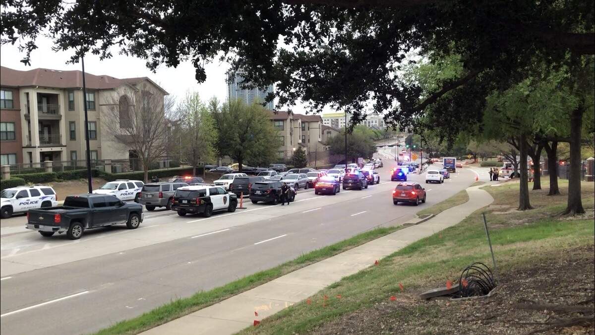 Police monitor the area where a Texas state trooper was shot Friday, March 29 in Frisco as the search for the shooter continued.
