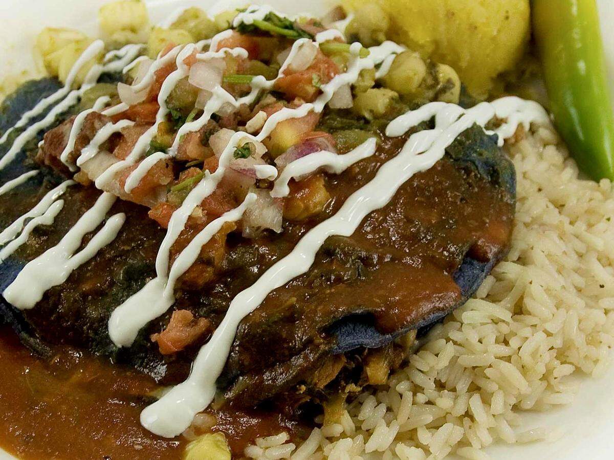 A Hatch green chile stacked enchilada plate at Blue Mesa Grill.