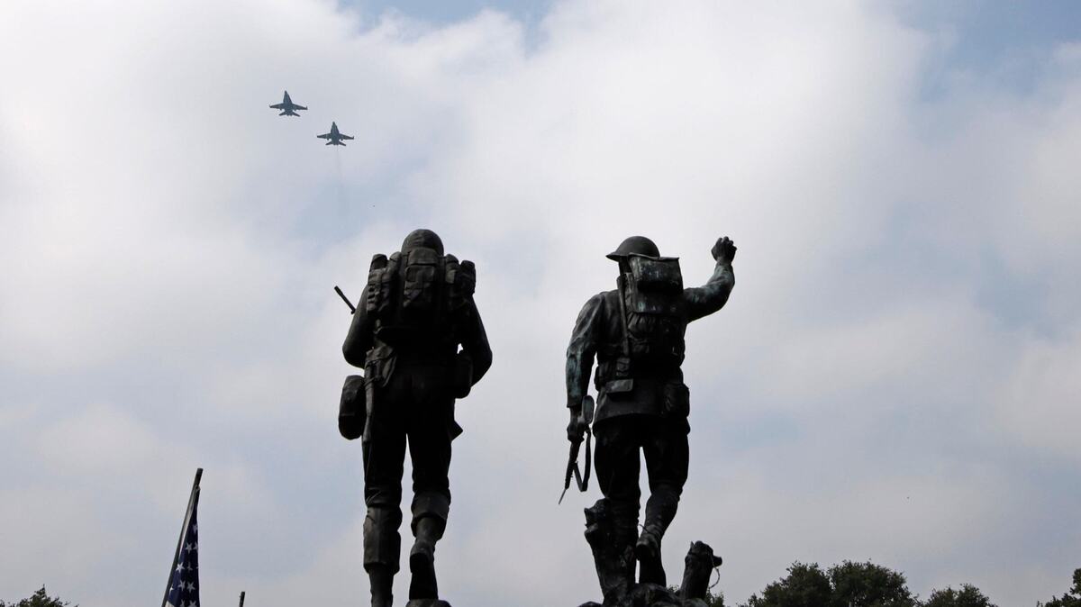 Jets fly over the Doughboy and American GI statues to start the Memorial Day Service at Mount Olivet Cemetery in Fort Worth, Texas, Monday May 27, 2024. A flyover, prominent city speakers and veterans from every branch attended the event. (Special to the Star-Telegram/Bob Booth)
