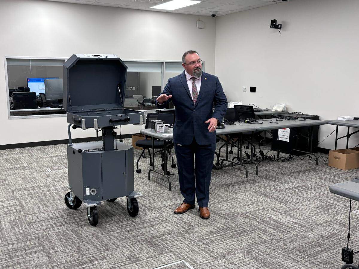 Tarrant County Elections Administrator Clint Ludwig presents the county’s new curbside voting apparatus at a public test of voting equipment and processes on Sept. 16, 2024.
