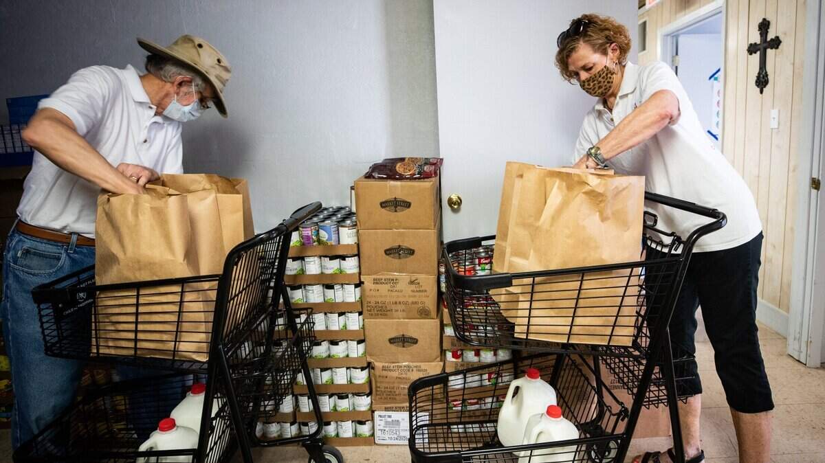 Volunteers are critical to Tarrant Area Food Bank’s mission of fighting hunger across North Texas. Here, Patti Callahan, right, fills a grocery bag for a food giveaway at 4Saints Episcopal Food Pantry on May 29, 2020, at St. Luke’s in the Meadow Episcopal Church in Fort Worth.