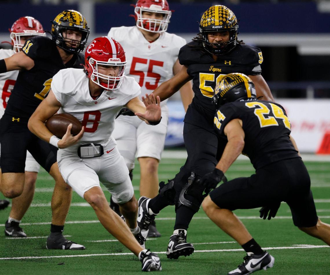 Columbus quarterback Adam Schobel (8) prepares to stiff arm Malakoff wide linebacker James Studley (24) during the UIL 3A D1 State Championship football game at AT&T Stadium in Arlington, Texas, Thursday, Dec. 19, 2024.