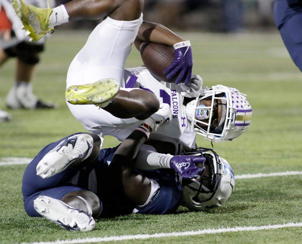 Timber Creek’s Caleb Mendji is brought down by L.D. Bell’s George Getanda during their UIL football game Friday night at Pennington Field In Hurst on Friday Sept. 6, 2024.