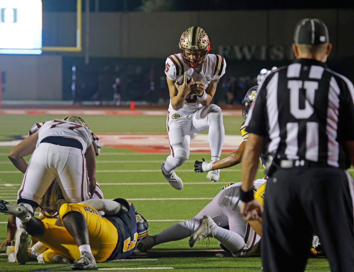 Saginaw quarterback Roman Morales (5) jumps the line bur is stopped for no gain during a District 4-5A D1 football game at Farrington Field in Fort Worth, Texas, Thursday, Oct. 10, 2024. (Special to the Star-Telegram / Bob Booth)