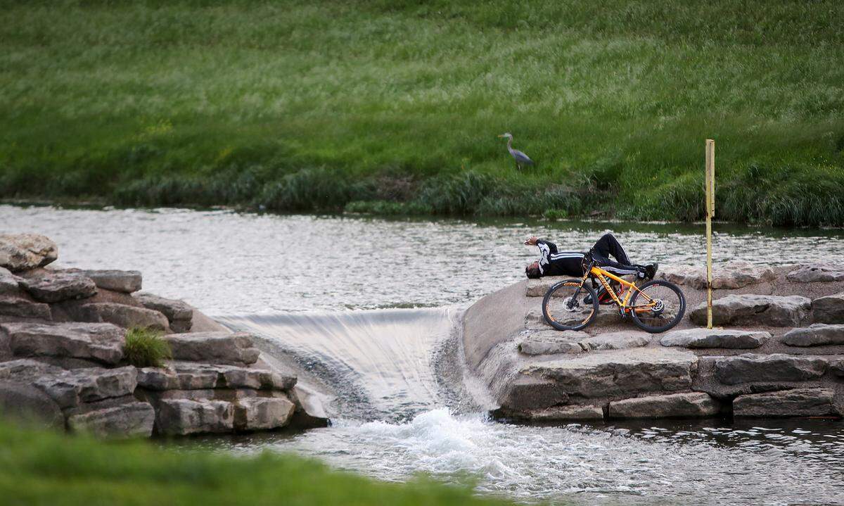 A man listens to music while relaxing on a warm spring evening at Trinity Park 