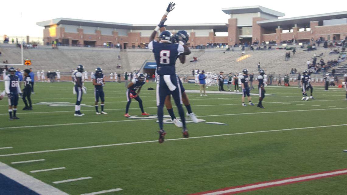 Allen senior Ja’Juan Mason high-fives a teammate prior to kickoff against Prosper in a District 9-6A game Friday night at Eagle Stadium in Allen.