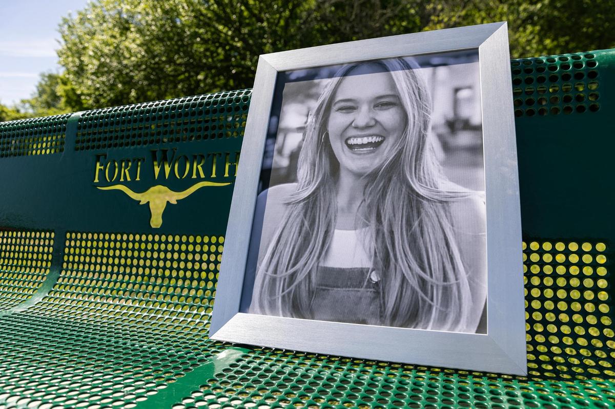 A portrait of Sara Hanson is placed on her memorial bench at Quail Ridge Park in Fort Worth on April 11, 2024. Hanson was shot and killed by her boyfriend, Garrett Benson, in their hotel room in Bossier City, Louisiana, in August 2020.